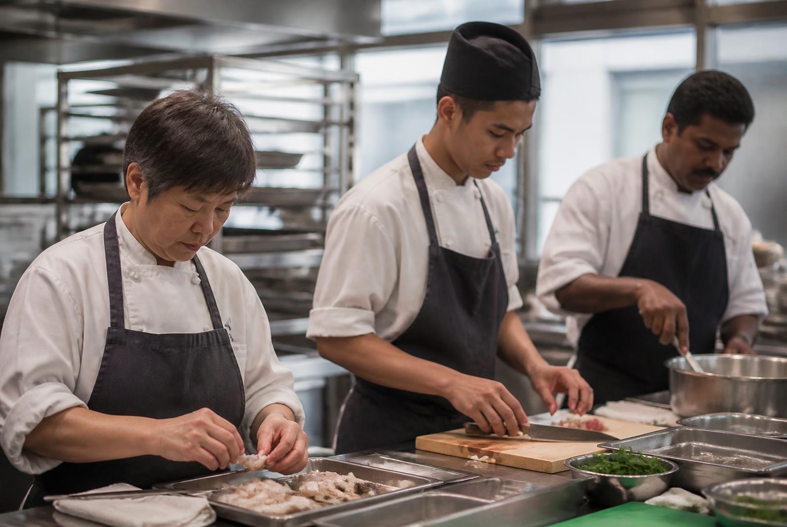 Team preparing food together in a bright, modern kitchen